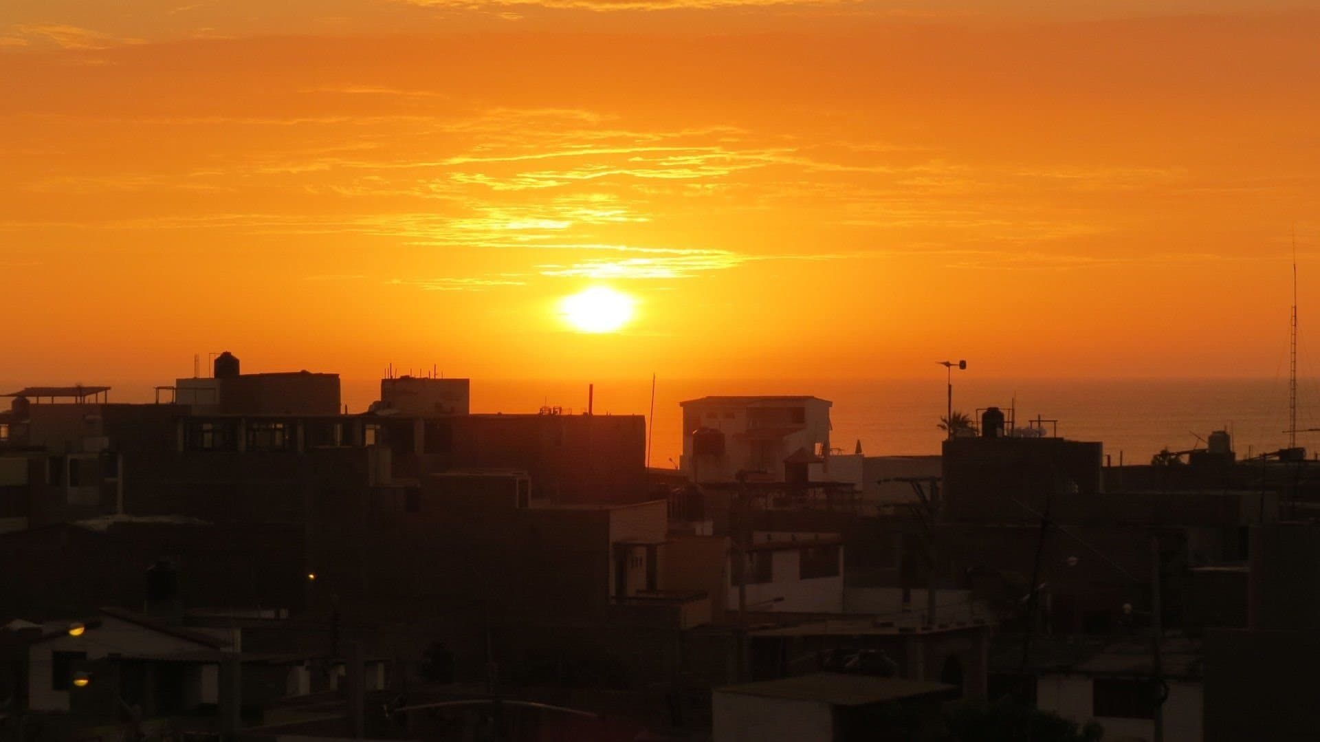The sun setting over the rooftops of Huanchaco