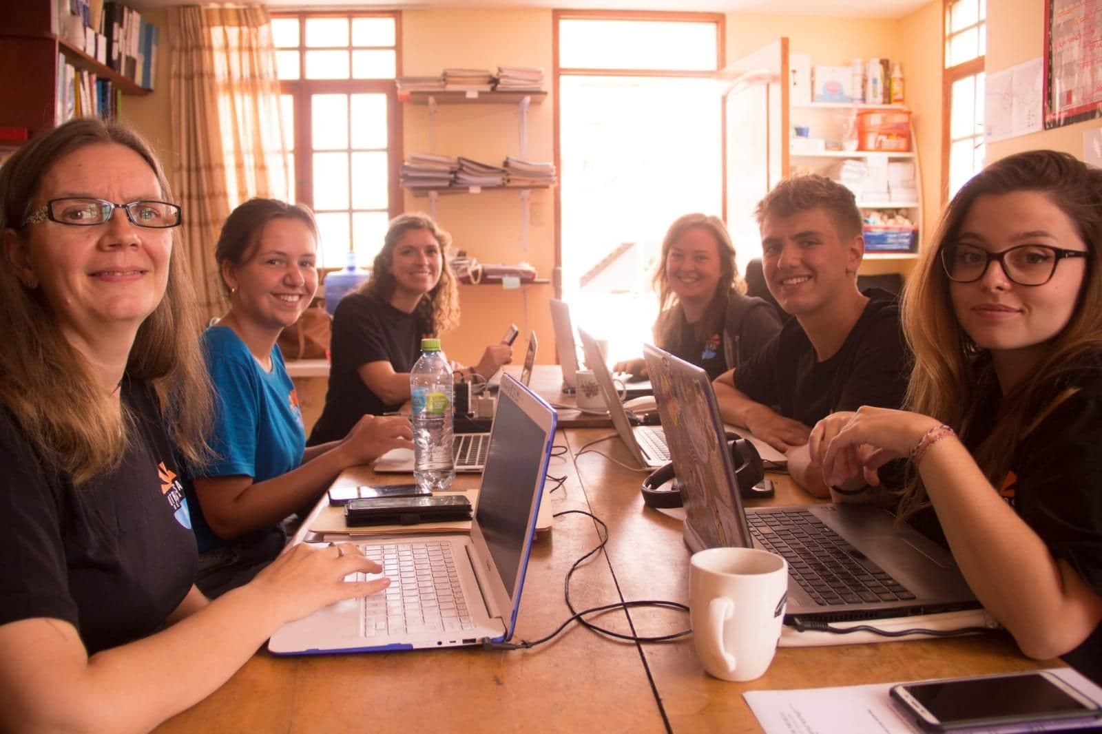 OCN team members planning together around laptops in the office