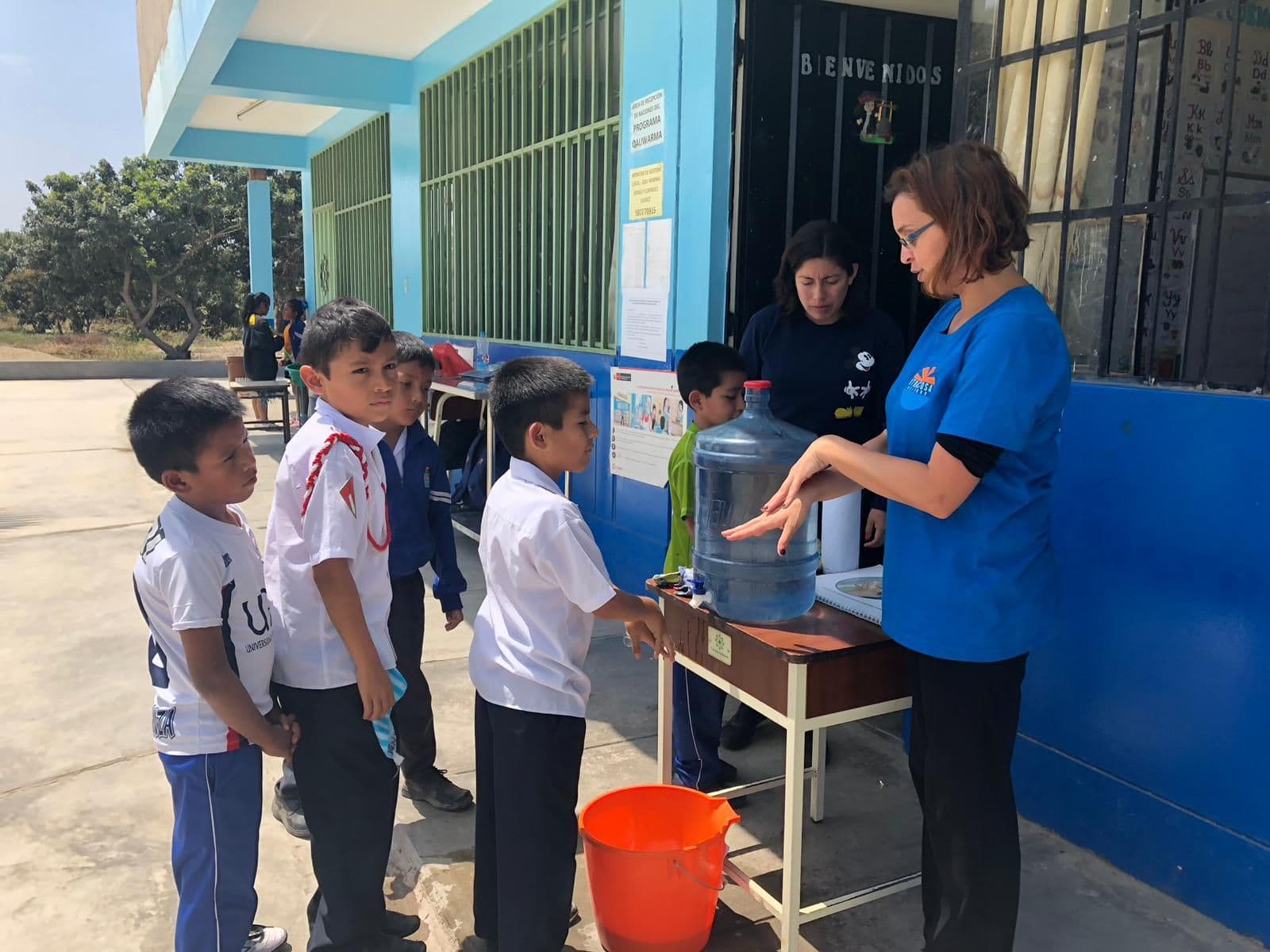 Schoolchildren queuing to wash their hands