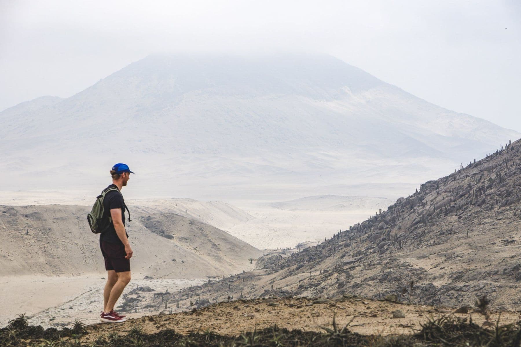A volunteer hiking across the desert hills behind Huanchaco