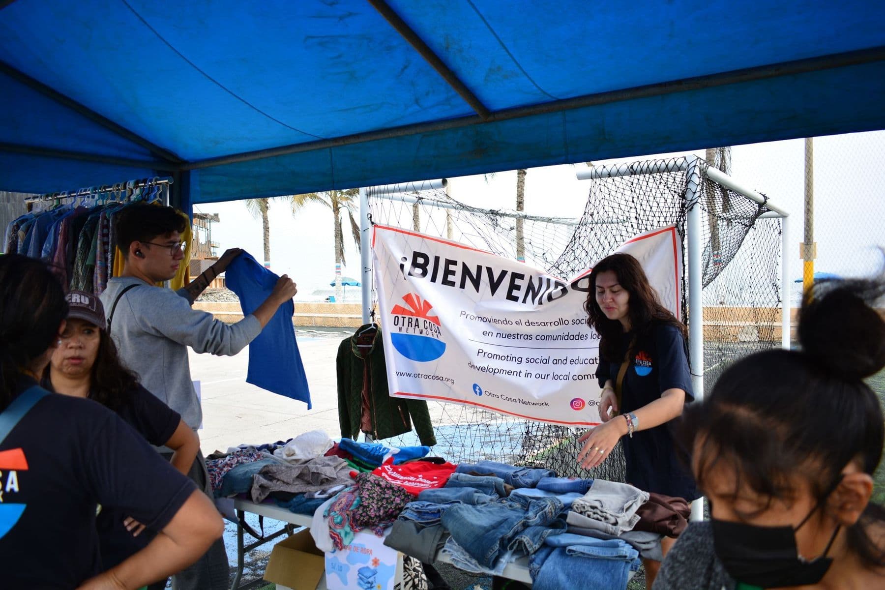 Volunteers running a colourful fundraising stall under a gazebo
